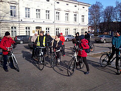 Uczestnicy warsztatów rowerowych w litewskiej Kłajpedzie. Na pierwszym planie grupa rowerzystów, w tle ulice z pasem rowerowym i budynki.